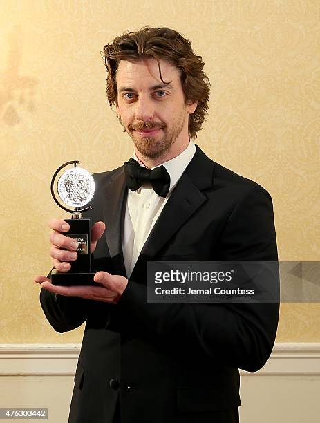 Christian Borle, winner of the award for Best Performance by an Actor in a Featured Role in a Musical for "Something Rotten!," poses in the press...