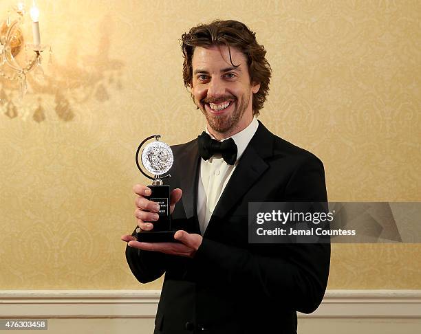 Christian Borle, winner of the award for Best Performance by an Actor in a Featured Role in a Musical for "Something Rotten!," poses in the press...