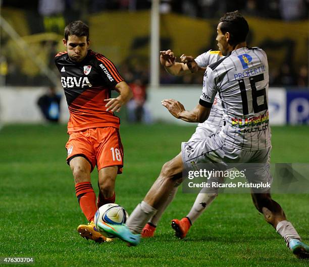 Camilo Mayada of River Plate fights for tha ball with Juan Leandro Quiroga of Olimpo during a match between Olimpo and River Plate as part of 15th...