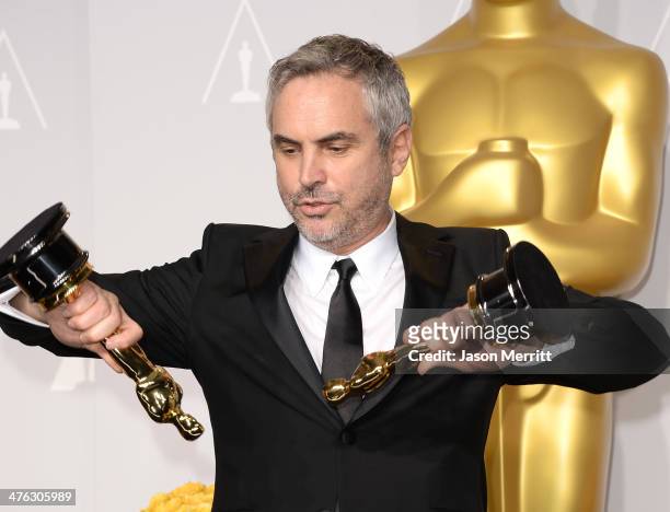 Director Alfonso Cuarón, winner of Best Achievement in Directing poses in the press room during the Oscars at Loews Hollywood Hotel on March 2, 2014...