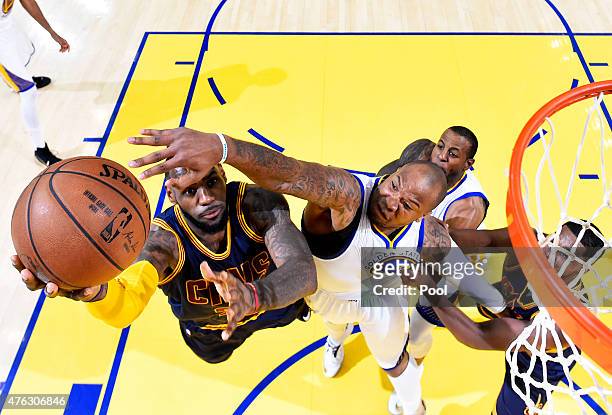 LeBron James of the Cleveland Cavaliers goes up against Marreese Speights of the Golden State Warriors in the first half during Game Two of the 2015...