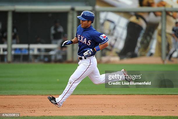 Kensuke Tanaka of the Texas Rangers runs the bases to score in the seventh inning against the Chicago White Sox on March 2, 2014 in Surprise, Arizona.