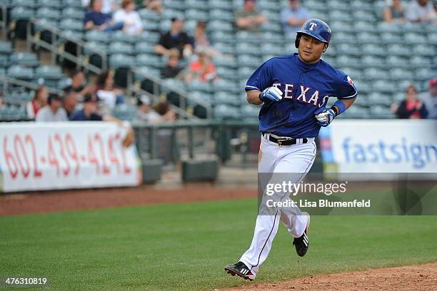 Kensuke Tanaka of the Texas Rangers runs the bases to score in the seventh inning against the Chicago White Sox on March 2, 2014 in Surprise, Arizona.