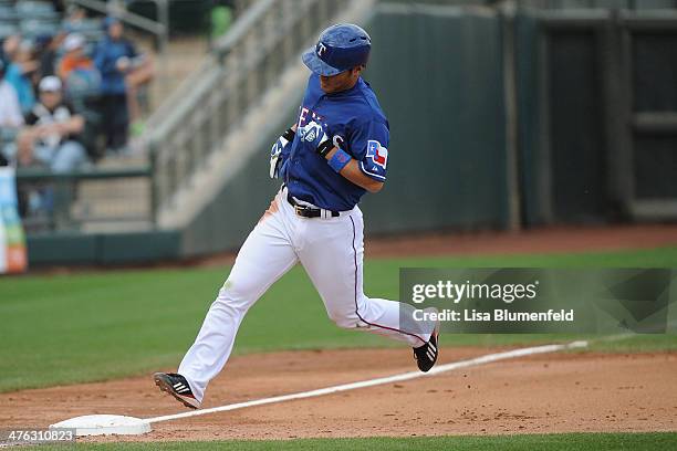 Kensuke Tanaka of the Texas Rangers runs the bases to score in the seventh inning against the Chicago White Sox on March 2, 2014 in Surprise, Arizona.