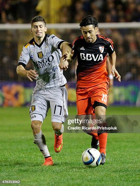 Leonardo Pisculichi of River Plate fights for the ball with Joel Amoroso of Olimpo during a match between Olimpo and River Plate as part of 15th...