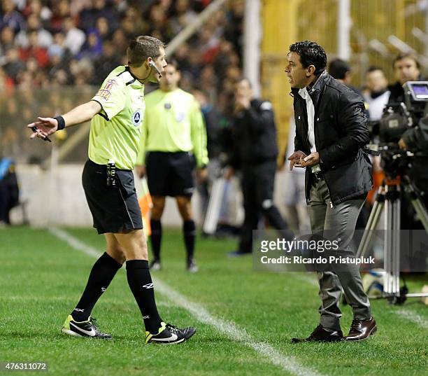 Referee German Delfino argues with coach Marcelo Gallardo of River Plate during a match between Olimpo and River Plate as part of 15th round of...