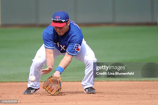 Kensuke Tanaka of the Texas Rangers fields the ball in the eighth inning against the Chicago White Sox on March 2, 2014 in Surprise, Arizona.