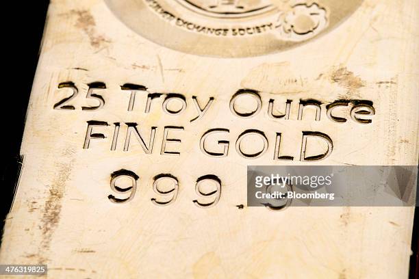 Troy ounce gold bar is arranged for a photograph at the Chinese Gold and Silver Exchange Society in Hong Kong, China, on Wednesday, Feb. 26, 2014....