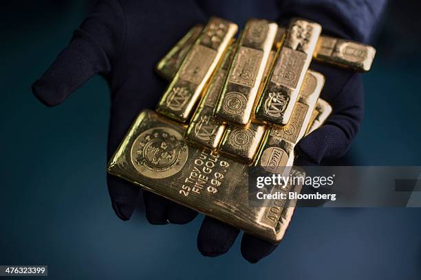 Troy ounce, bottom, and five tael gold bars are arranged for a photograph at the Chinese Gold and Silver Exchange Society in Hong Kong, China, on...