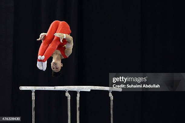 Dinh Phuong Thanh of Vietnam in action during the parallel bar event in the men's gymnastic individual all-around final at the Bishan Sports Hall...