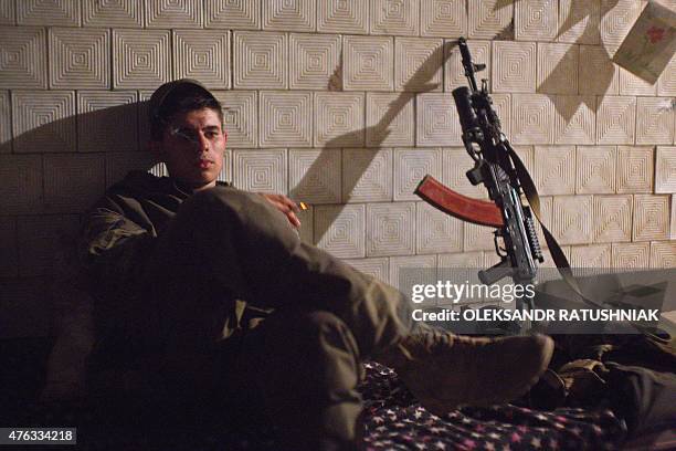 Ukrainian serviceman rests on the position of Ukrainian forces on the front line near Opytne village, not far from Donetsk airport after the battle...