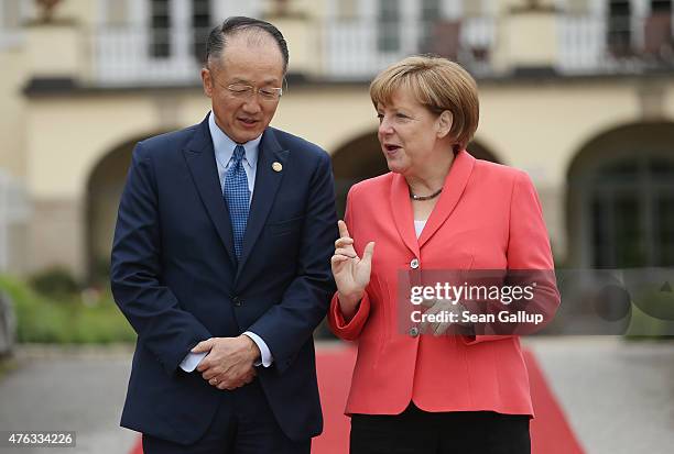 German Chancellor Angela Merkel greets President of the World Bank Group Jim Yong Kim on the second day of the summit of G7 nations at Schloss Elmau...