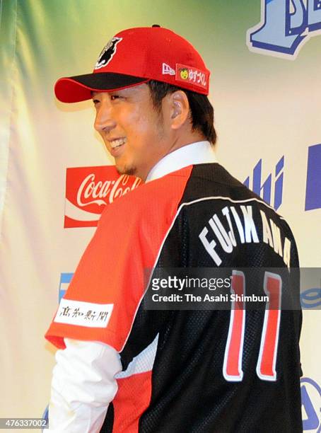Former Chicago Cubs and Texas Rangers reliever Kyuji Fujikawa poses for photographs during a press conference announcing to join the Japanese...