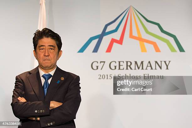 Japan's Prime Minister Shinzo Abe waits for the arrival of Britain's Prime Minister David Cameron as they conduct a bilateral meeting at the summit...