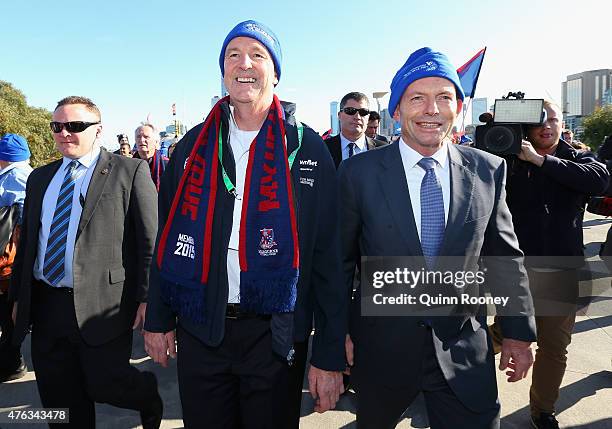 Neale Daniher and prime minister Tony Abbott walk to the MCG ahead of the round 10 AFL match between the Melbourne Demons and the Collingwood Magpies...