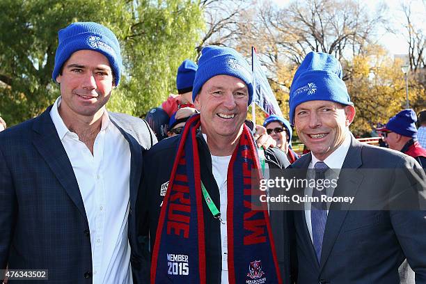 Gillon McLachlan, Neale Daniher and prime minister Tony Abbott pose for a photo as they walk to the MCG ahead of the round 10 AFL match between the...