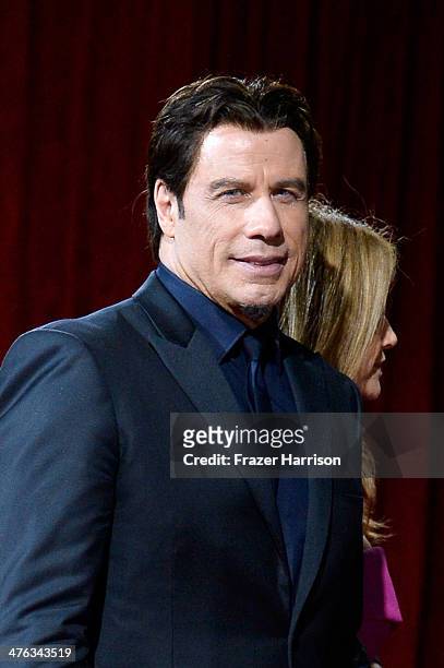 Actors John Travolta and Kelly Preston depart the Oscars at Hollywood & Highland Center on March 2, 2014 in Hollywood, California.