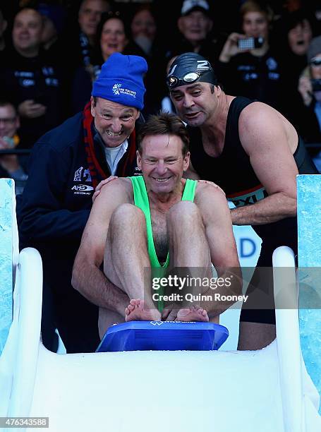 Neale Daniher and Gary Lyon push Sam Newman into an icebath to raise money for Motor Neurone Disease ahead of the round 10 AFL match between the...