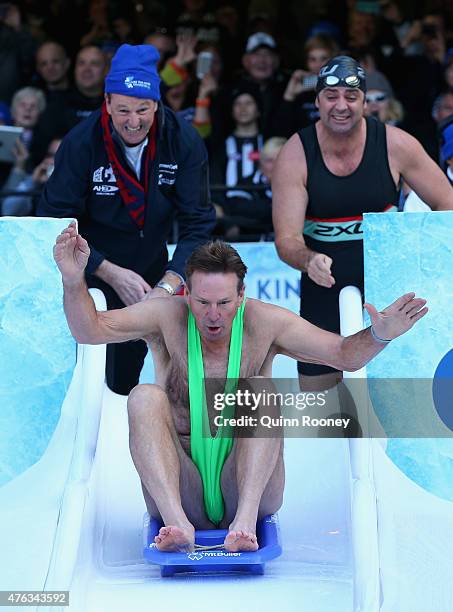 Neale Daniher and Gary Lyon push Sam Newman into an icebath to raise money for Motor Neurone Disease ahead of the round 10 AFL match between the...