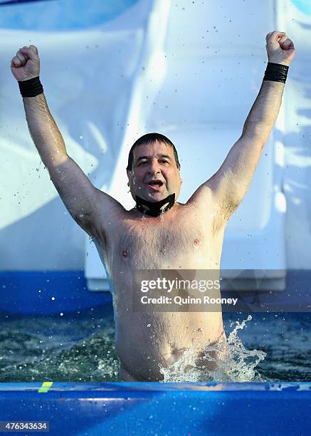 Mick Molloy dives into an icebath to raise money for Motor Neurone Disease ahead of the round 10 AFL match between the Melbourne Demons and the...