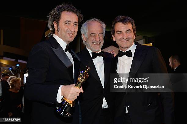 Director Paolo Sorrentino celebrates with Actor Toni Servillo and guest after winning Best Foreign Language Film for 'The Great Beauty' during the...