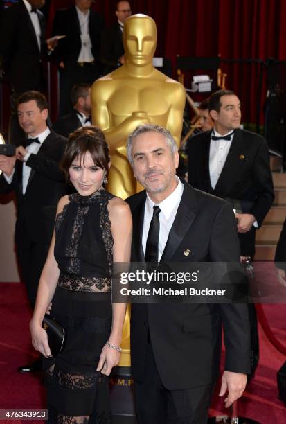 Filmmaker Alfonso Cuaron and Sheherazade Goldsmith attends the Oscars held at Hollywood & Highland Center on March 2, 2014 in Hollywood, California.