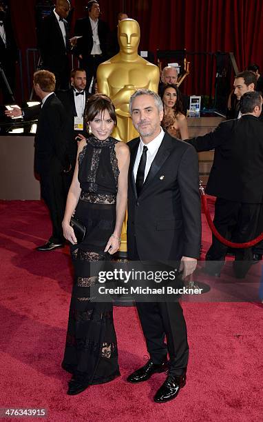 Filmmaker Alfonso Cuaron and Sheherazade Goldsmith attends the Oscars held at Hollywood & Highland Center on March 2, 2014 in Hollywood, California.