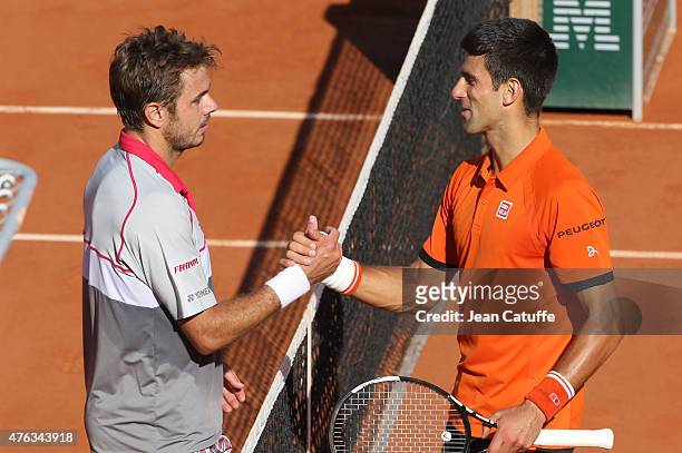 Winner Stanislas Wawrinka of Switzerland shakes hands with Novak Djokovic of Serbia after the men's final on day 15 of the French Open 2015 at Roland...