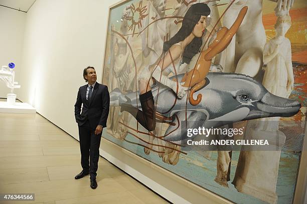 Artist Jeff Koons poses past one of his piece of art during the presentation of the "Jeff Koons: Retrospective" exhibition at the Guggenheim Bilbao...