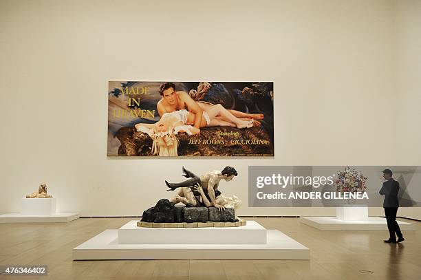 Man looks at US artist Jeff Koons' artworks titled "Made in Heaven" during the presentation of the "Jeff Koons: Retrospective" exhibition at the...