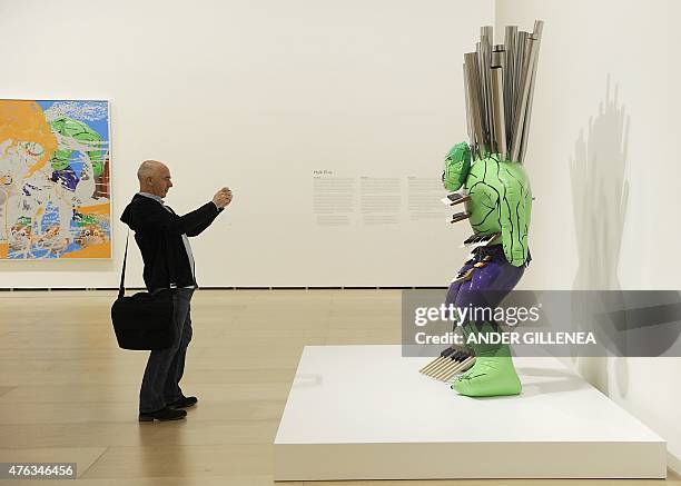Man takes pictures of US artist Jeff Koons' artwork titled "Hulk Elvis" during the presentation of the "Jeff Koons: Retrospective" exhibition at the...