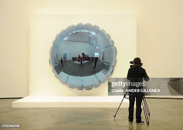 Man films a US artist Jeff Koons' artwork titled "Moon" during the presentation of the "Jeff Koons: Retrospective" exhibition at the Guggenheim...