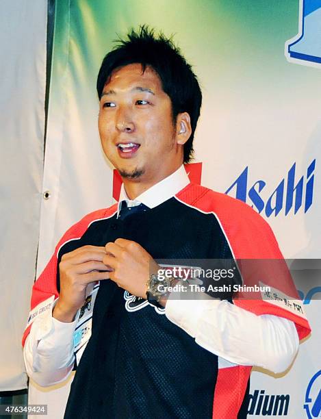 Former Chicago Cubs and Texas Rangers reliever Kyuji Fujikawa poses during a press conference announcing he is joining the Japanese Independent...