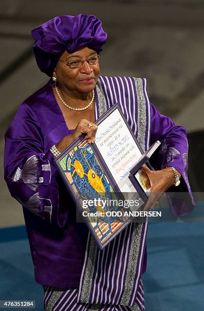 Nobel Peace Prize laureate, Liberian President Ellen Johnson Sirleaf, poses with her medal and certificate on December 10, 2011 during the Nobel...