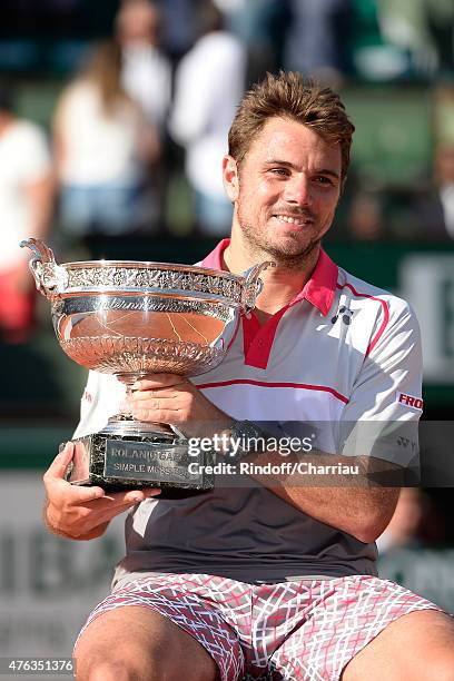 Stanislas Wawrinka of Switzerland poses with the Coupe de Mousquetaires after victory in the Men's Singles Final against Novak Djokovic of Serbia on...