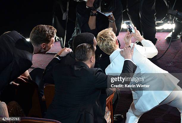 Actor Chiwetel Ejiofor, actor/Producer Brad Pitt and Host Ellen DeGeneres take a selfie in the audience during the Oscars at the Dolby Theatre on...