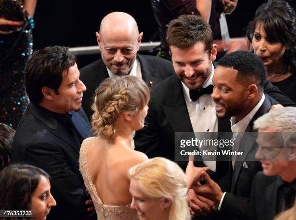 John Travolta, Suki Waterhouse, Bradley Cooper and Will Smith talk during the Oscars at the Dolby Theatre on March 2, 2014 in Hollywood, California.