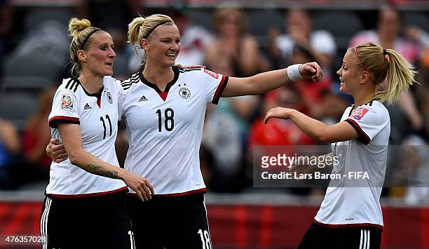 Anja Mittag of Germany celebrates with team amtes after scoring her teams third goal during the FIFA Women's World Cup 2015 Group B match between...