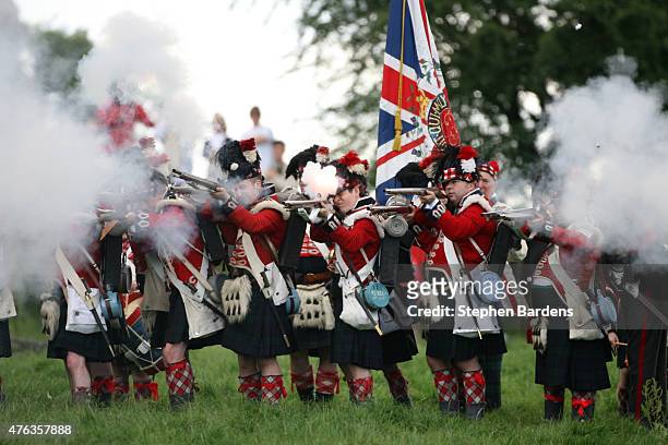 Historical re-enactors dressed as British Highlanders participate in a Battle of Waterloo re-enactment on June 17, 2007 in Waterloo, Belgium.