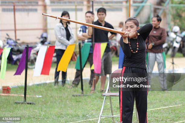 Participants were competing in a Sumpit tournament, during the Gawai Dayak Naik Dango. Sumpit is a traditional weapon of the Dayak in Kalimantan.