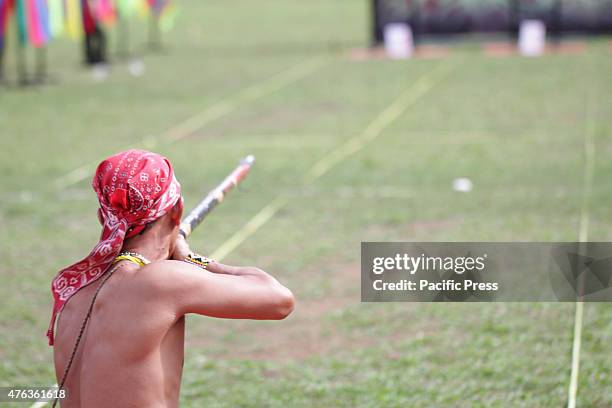 Participants were competing in a Sumpit tournament, during the Gawai Dayak Naik Dango. Sumpit is a traditional weapon of the Dayak in Kalimantan.