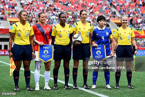 Trine Ronning of Norway and Duangnapa Sritala of Thailand pose with the referee team prior to the FIFA Women's World Cup 2015 Group B match between...