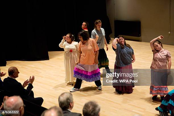 Prince Philip, Duke of Edinburgh, applauds students at the end of a performance during his visit to Richmond Adult Community College in Richmond on...