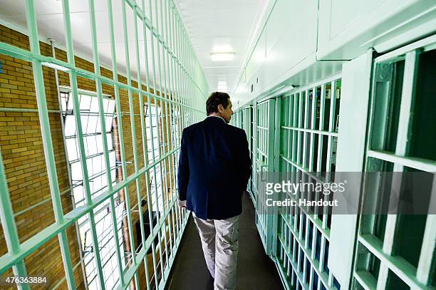 In this handout from the New York State Governor's Office, New York Gov. Andrew Cuomo walks past jail cells where two convicted murderers fled from...