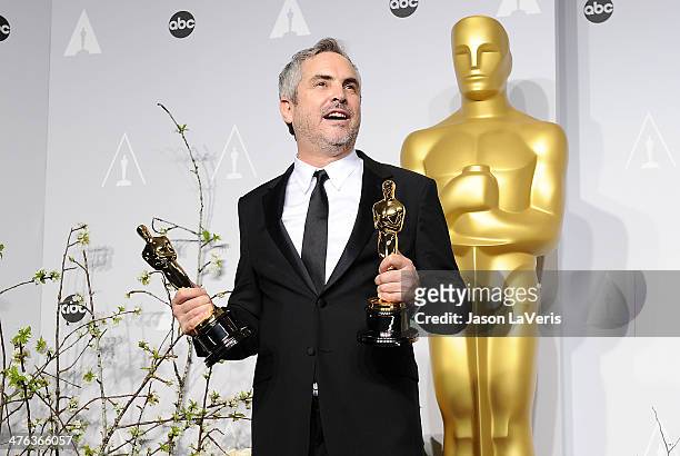 Director Alfonso Cuaron poses in the press room at the 86th annual Academy Awards at Dolby Theatre on March 2, 2014 in Hollywood, California.