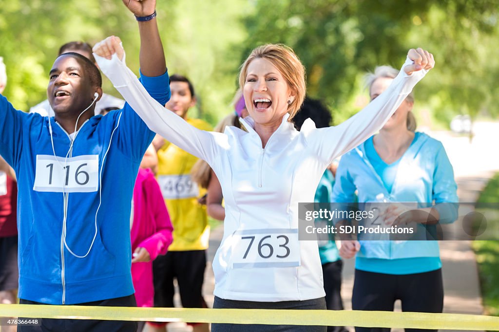 Happy runners celebrating as they win marathon or 5k race