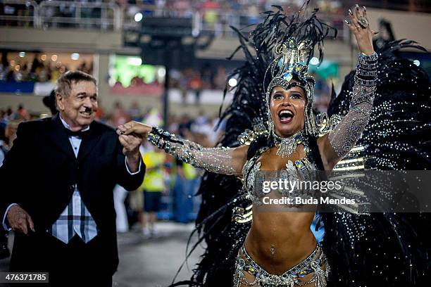 Jose Bonifacio de Oliveira Sobrinho honored with the school's theme, dances with the Queen of Percussion Raissa Oliveira of Beija Flor Samba School...