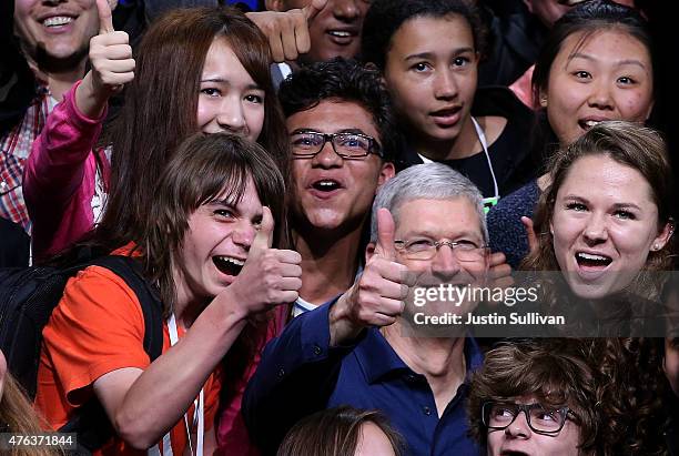 Apple CEO Tim Cook poses for a photo with high school kids during Apple WWDC on June 8, 2015 in San Francisco, California. Apple annouced a new OS X,...