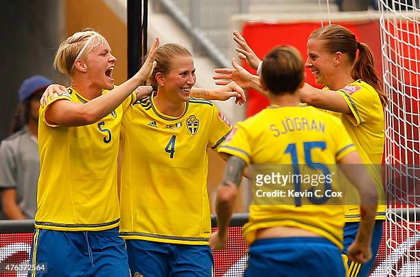 Nilla Fischer of Sweden reacts after scoring the second goal against Nigeria with Emma Berglund, Therese Sjogran, and Lotta Schelin during the FIFA...