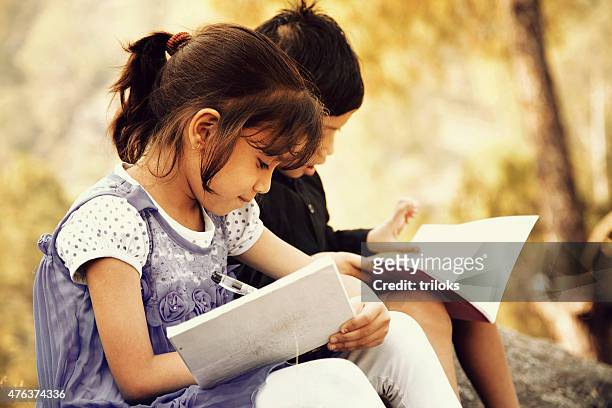 village girl studying with her brother - pakistan school stock pictures, royalty-free photos & images